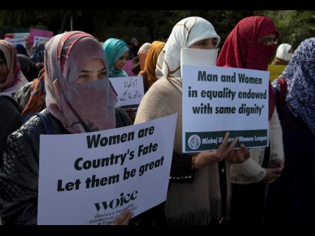 Activists of the Pakistani religious party, Minhaj-ul-Quran, observe International Women’s Day at a rally in Islamabad, Pakistan. 