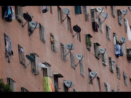 
DirectTV satellite dishes dot the facade of the Great Mission public housing project in Caracas, Venezuela, on May 22.
