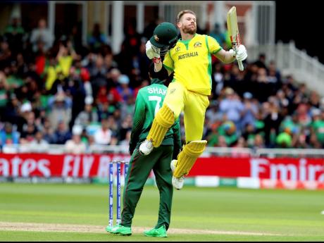 Australia’s David Warner leaps into the air to celebrate scoring a century during the Cricket World Cup match between Australia and Bangladesh at Trent Bridge in Nottingham, England, last year.