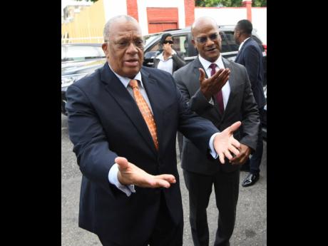 In this September 10, 2019 photo, Opposition Leader Dr Peter Phillips (left) and Peter Bunting arrive at a sitting of the House of Representatives at Gordon House. 