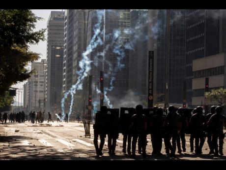 AP 
Police clash with anti-government demonstrators in São Paulo, Brazil, on Sunday, May 31. Police used tear gas to disperse anti-government protesters in Brazil’s largest city as they began to clash with small groups loyal to President Jair Bolsonaro.