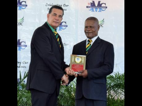 Rhudal Victor McFarlane (right) receiving the Spirit of Independence Award from Montego Bay Mayor Homer Davis last August.