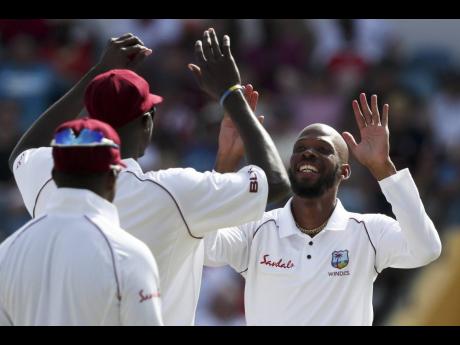 Windies all-rounder Roston Chase celebrates dismissing England’s Moeen Ali with teammates during Day Four of the first cricket Test match at the Kensington Oval in Bridgetown, Barbados on Saturday, January 26, 2019.