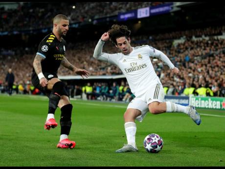 FILE
In this Wednesday, February 26, 2020 file photo, Real Madrid’s Isco (right) duels for the ball with Manchester City’s Kyle Walker during the Champions League, round of 16, first-leg match between Real Madrid and Manchester City at the Santiago Ber