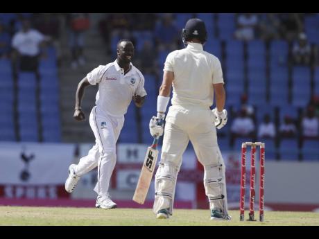 
West Indies’ Kemar Roach (left) celebrates after dismissing England’s Rory Burns during day one of the second Test cricket match at the Sir Vivian Richards Stadium in North Sound, Antigua and Barbuda, Thursday, January 31, 2019.