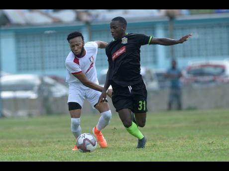 Molynes United’s Fakibi Farquharson (right) is challenged for possession by Arnett Gardens’ Odane Samuels during a Red Stripe Premier League encounter at the Waterhouse Stadium on Sunday, September 22, 2019.
