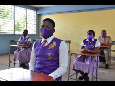 Fifth-form student and head boy at Pembroke Hall High School in St Andrew, Darrion Anderson (foreground), said he was more than happy to be back in a physical classroom after a three-month break.