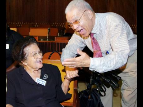 Sybil Francis (left), former director of the Social Welfare Training Centre and chairman of the National Council for Senior Citizens, shares a light moment with Clinton Davis, president of the Jamaica Government Pensioners’ Association, at the disclosure