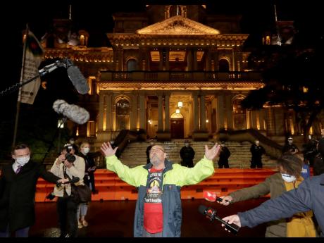A lone protester makes a statement at Town Hall in Sydney, Friday, June 12, 2020, to support US protests over the death of George Floyd. Hundreds of police disrupted plans for a Black Lives Matter rally, but protest organisers have vowed that other rallies