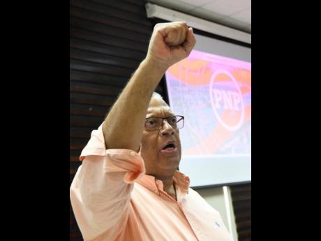 PNP President Dr Peter Phillips salutes supporters during an address to a special conference of prospective candidates at the Faculty of Law Lecture Theatre of The University of the West Indies on Sunday.