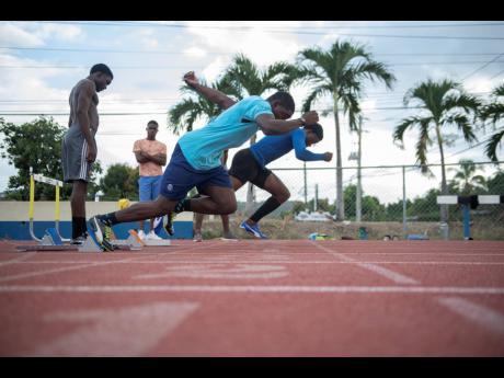 Jamaica College sprinters Jonathan Henry (foreground) and Christopher Scott both launch out of the starting block during a training session held at the Ashenheim Stadium on February 20, 2020. 
