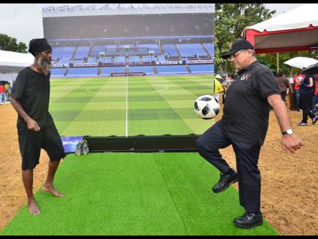 British High Commissioner to Jamaica, Asif Ahmad (right) displays expert skill in a game of keep-up with Soccer Aerobics Instructor Lyndon ‘Lele’ Adlam at the Third Annual UK Jamaica Fair on Saturday, February 29, 2020, on the West Lawns of King’s Ho
