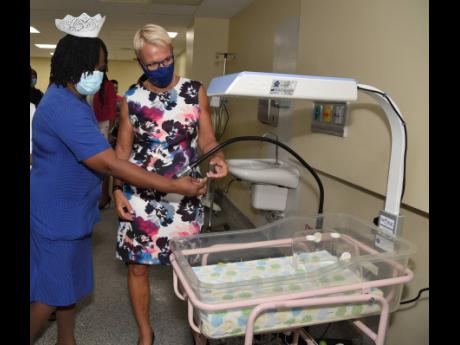 Elise Fairweather-Blackwood (left), director of nursing services at Victoria Jubilee Hospital, explains the workings of an incubator at the VJH to Malgorzata Wasilewska (right), head, European Union Delegation to Jamaica, shortly after the official opening