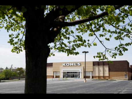 An empty parking lot is seen at a temporarily closed Kohl’s department store, on Wednesday, April 29, in Havertown, Pennsylvania.  Devastated by the coronavirus, the US economy is sinking.