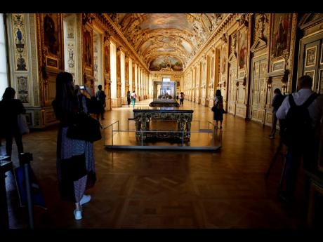 
Journalists take pictures of the Galerie d’Apollon during a visit to the Louvre museum ahead of its reopening next July 6.