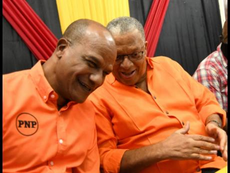 People’s National Party Co-Campaign Director Peter Bunting (left) chuckles with party President Dr Peter Phillips at a meeting of councillors and councillor caretakers at The Mico University College in Kingston on Sunday.