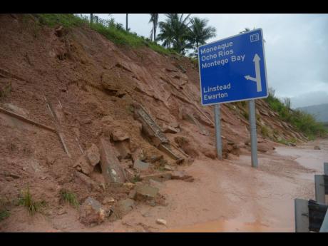 This file photo from 2017 shows a section of the retaining wall along the North Coast Toll road that collapsed after heavy rains.