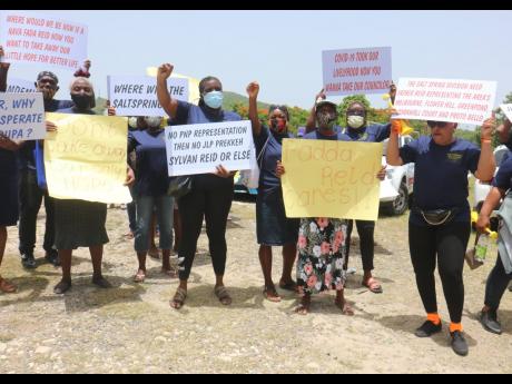 Some of the protesters in Salt Spring, St James, who yesterday voiced their opposition to the move by the St James Municipal Corporation to disqualify their representative, Sylvan Reid, and his colleague from the Catadupa Division, Gladstone Bent, as counc