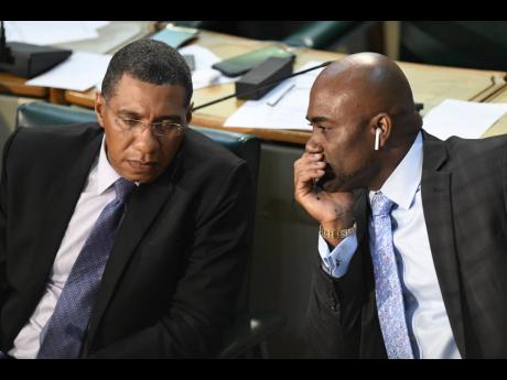 Prime Minister Andrew Holness (left) listens keenly to then Energy Minister Andrew Wheatley at a sitting of the House of Representatives on Thursday, March 15, 2018. Wheatley later stepped down amid an unfolding Petrojam scandal.