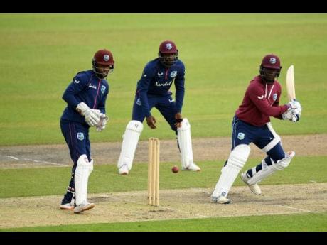 Windies Jamaican batsman Nkrumah Bonner (right) plays a shot through the slips while at the innings for Jason Holder’s XI on the final day of their inter-squad warm-up game at Old Trafford in Manchester, England, yesterday.