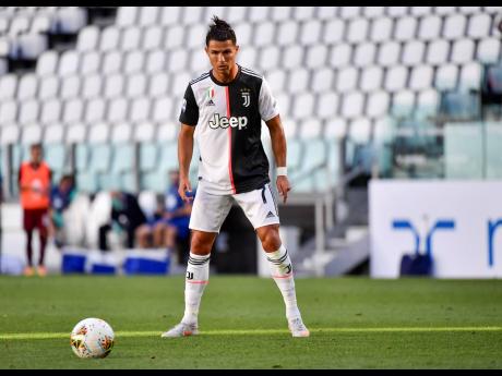 
Juventus’ Cristiano Ronaldo concentrates moments before scoring his side’s third goal on a free-kick, during the Serie A match between Juventus and Torino, at the Allianz Stadium in Turin, Italy, yesterday. Juventus won 4-1.