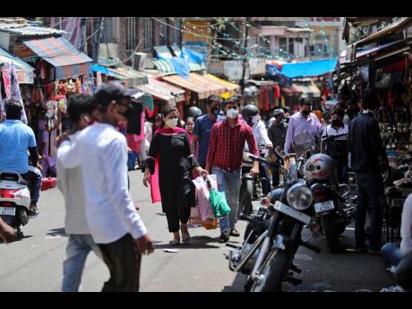 Indians wearing masks as a precaution against the coronavirus shop at a market in Jammu, India on Sunday, July 5, 2020. India’s coronavirus caseload is fourth in the world behind the US, Brazil and Russia. 