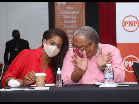 People’s National Party President Dr Peter Phillips in dialogue with Lisa Hanna, chief campaign spokesperson, at a meeting of Regions One and Six councillors and councillor caretakers at the S Hotel in Montego Bay, St James, on Sunday.