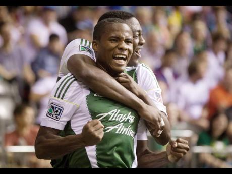 Former Portland Timbers’ defender Alvas Powell (foreground) celebrates with teammate Fanendo Adi after scoring against the Vancouver Whitecaps in a MLS match in 2014. Powell now represents Inter Miami. 