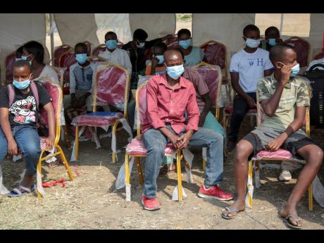 Members of the public wait to be tested for the coronavirus in Bujumbura, Burundi, yesterday. 