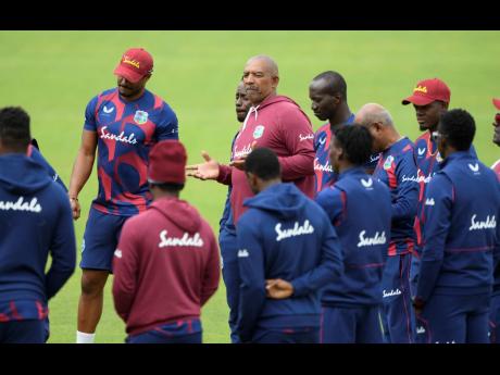 West Indies coach Phil Simmons (centre) speaks to his team members during a nets session at the Ageas Bowl in Southampton, England, yesterday. West Indies play their first Test match against England starting today.