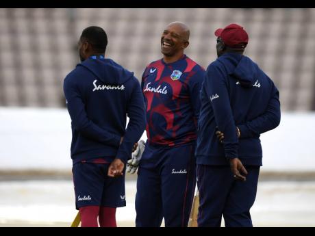 West Indies' team coach Phil Simmons (centre), shares a laugh with members of support staff before the start of the first day of the 1st cricket Test match between England and West Indies, at the Ageas Bowl in Southampton, England, Wednesday July 8, 2020. 