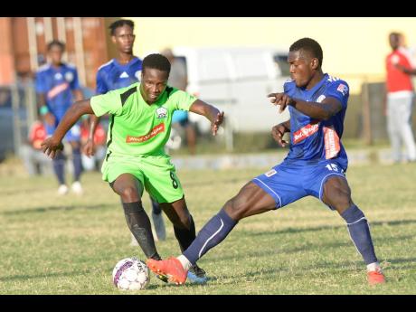 Mount Pleasant’s Kevaughn Isaacs (right) gets a toe to the ball ahead of Molynes United’s Tyrique Wilson during a Red Stripe Premier League match at the Constant Spring Sports Complex on Sunday, December 15, 2019.