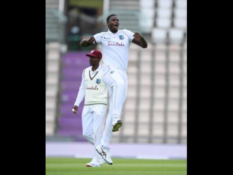 Windies’ captain Jason Holder celebrates the dismissal of England’s Jos Buttler during the second day of the first cricket Test match at the Ageas Bowl in Southampton, England, yesterday.