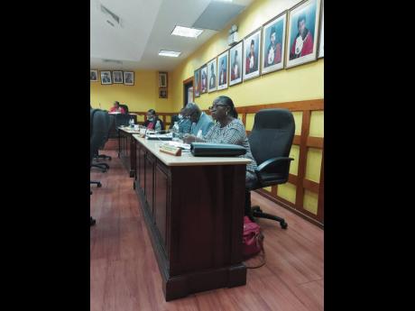 Faith Sampson-Nickle (right) sits with Jamaica Labour Party councillors after crossing the floor yesterday.
