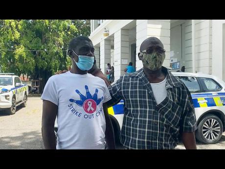Mentally challenged farmer of St Elizabeth Abraham Lawrence (left) and his brother, Llewellyn, leave the Santa Cruz Parish Court yesterday. Abraham was freed after spending more than 25 years behind bars without being tried for alleged offences he committe