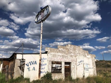 In this June 28, 2020, photo, an abandoned gas station in Tierra Amarilla, New Mexico, is shown with graffiti honoring the 1967 courthouse raid in the town by armed Mexican American land grant activists. Activists and cities are left wondering what to do w