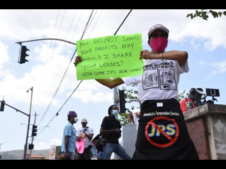 One of the protesters who on Saturday turned out to voice objection to what they saw as unusually high electricity bills and to speak out against the JPS charging paying customers for losses due to theft.