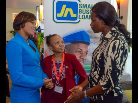 Beulah Kelly (right) of Kelly’s Water Sports makes a point to Gillian Hyde (left), general manager, JN Small Business Loans (JNSBL), and Thelma Yong, deputy general manager, JNSBL, during the Small Business Association of Jamaica MSME Conference at the H
