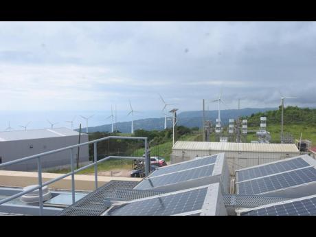 Above: The wind turbines are seen in the background from the solar-panelled rooftop of the Wigton Windfarms complex in St Elizabeth.