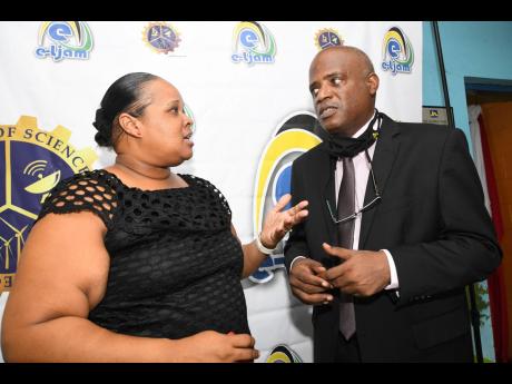 Tracey-Ann Holloway Richards, principal of Maxfield Park Primary, speaks with Keith Smith, CEO of e-Learning Jamaica, at a handover ceremony of tablets at Maxfield Park Primary School in Kingston on Tuesday, July 14. Approximately 25,000 tablets will be di