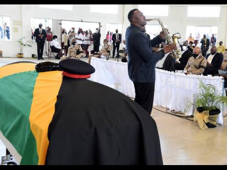 
Corporal Andre Gillespie, a member of the Jamaica Constabulary Force Band, performs a musical tribute during yesterday’s funeral service for Detective Corporal Dane Biggs, who was shot and killed by a gunman during an operation last month. The service w