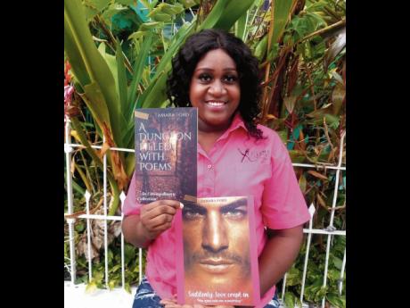 Caterer and first-time author Tamara Ford smiles for the camera as she displays her newest creations; a romance novel, titled ‘Suddenly Love Crept In’, and a compilation of poems called ‘A Dungeon Filled With Poems’.