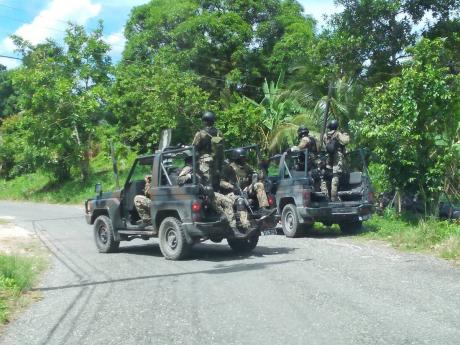 Members of the Jamaica Defence Force on an operation in Amity, St James, on Wednesday following the fatal shooting of Delano 'Prekeh Boy' Wilmot. 