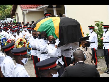 Ricardo Makyn/Chief Photo Editor 
A police bearer party carries the coffin with the remains of their fallen colleague, Constable Decardo Hylton, from the Bread of Life Ministries church in Linstead, St Catherine, after yesterday’s funeral.