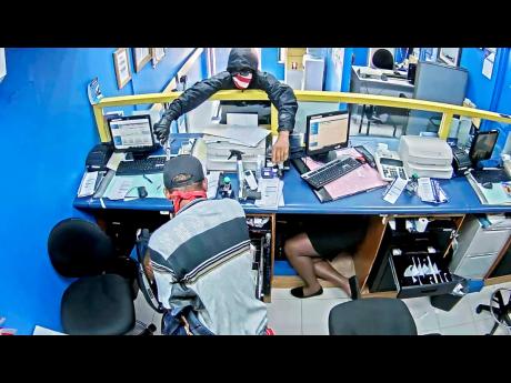 Masked robbers brandish weapons while making off with $3.2 million from the Whitehouse Money Shop branch of Jamaica National Bank on Tuesday.