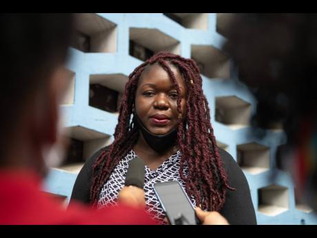 Sherine Virgo speaks with journalists outside the Supreme Court in Kingston on Friday following the verdict in a case where her daughter was denied, in 2018, the right to attend Kensington Primary School because of her dreadlocked hairstyle. The court rule