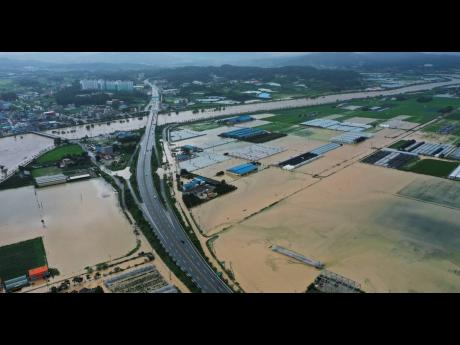 Agricultural lands are inundated with floodwaters after heavy rains in Anseong, South Korea.