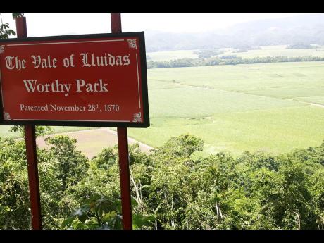 In this Gleaner file photo, the Worthy Park Estate canefields form the backdrop to a sign seen from the  Lluidas Vale main road in St Catherine.