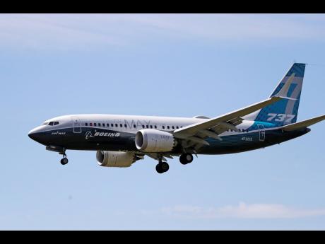 A Boeing 737 Max jet heads to a landing at Boeing Field following a test flight on June 29 in Seattle. 