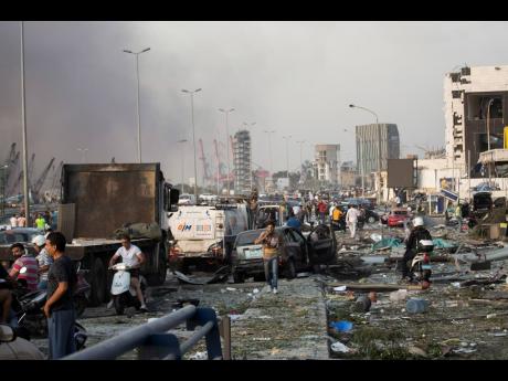 People evacuate wounded after of a massive explosion in Beirut, Lebanon, yesterday.